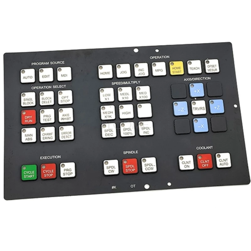 Black silicone membrane operator panel keypad for Fanuc Series 0T lathe control, with colour-coded cycle start, spindle and coolant keys, only the X and Z axis positions populated and the remainder blank, printed code #K OT along the bottom edge.